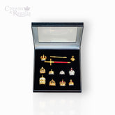Collection of crowns and a sword in a display box with 'Crowns & Regalia' branding.